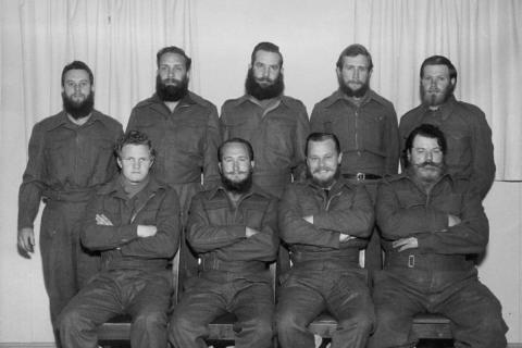 MARION 13 (April 1956-March 1957): Johan P. Bothma (Officer-in-Charge/Meteorologist, front second left), C. Coetser/Coertze (Medic, replaced F. Rossouw), Ken Edmunds (Radio Operator, front third left), P. Evens/Evers (Diesel Mechanic), A.J. Jacobs (Cook), P. Maré (Meteorologist), Cecil Neumann (Radio Technician, back left), Willem A. Huyssteen (Meteorologist, front left), A. von Meydell (Handyman).